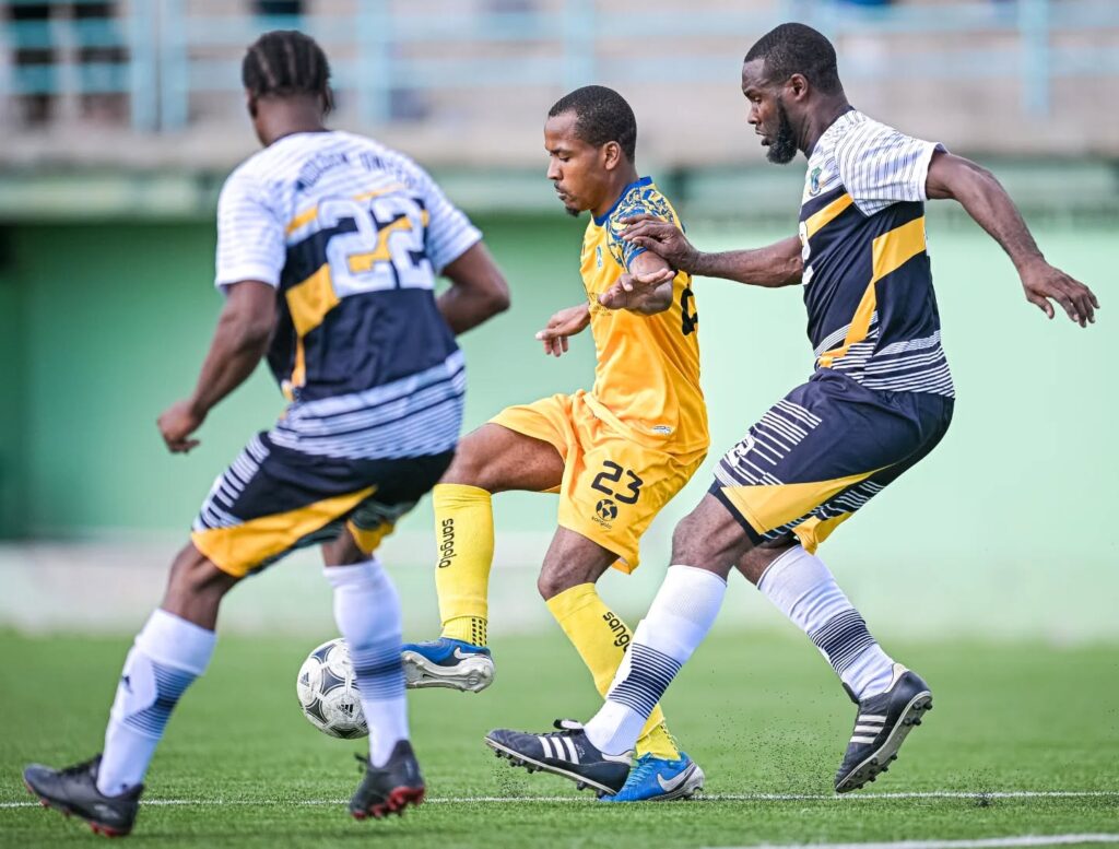 Middleham United FC player Kimon Jno Baptiste applying pressure to a Dublanc FC player