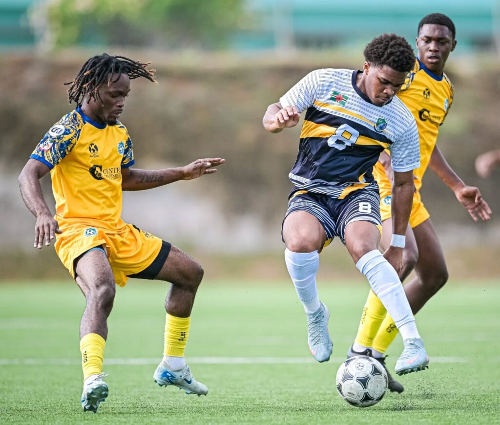Middleham United FC player Malachai Bonney between two Dublanc FC players