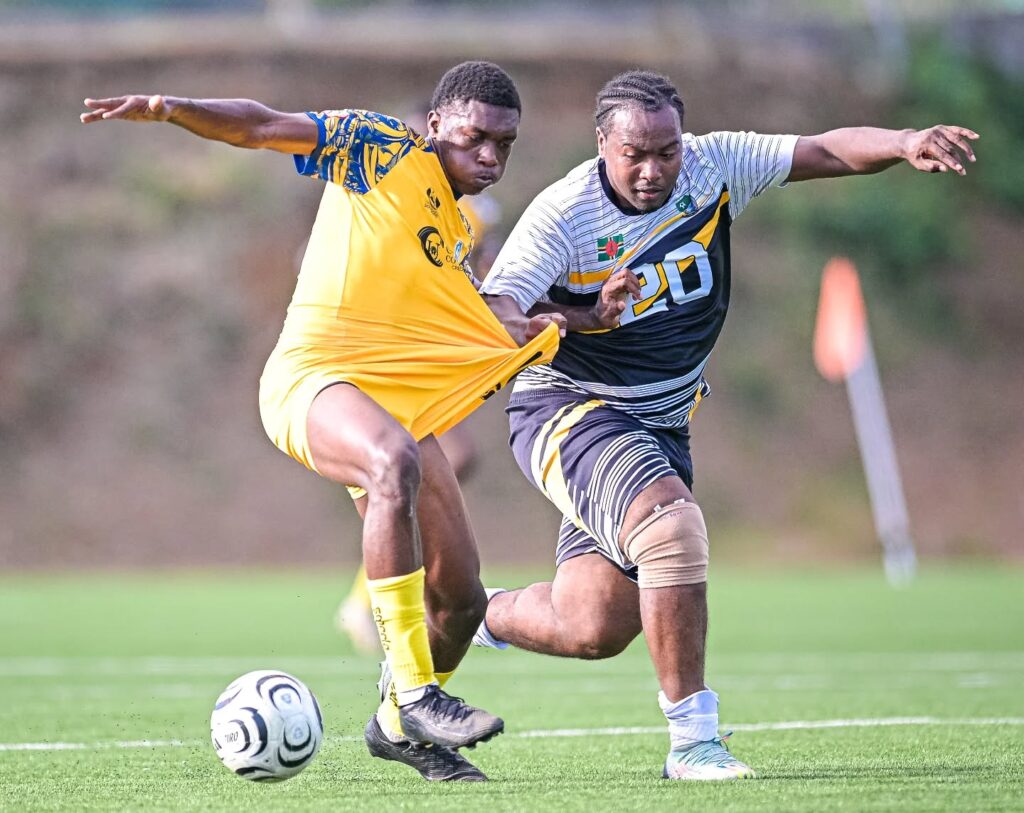 A Middleham United FC player tugging at a Dublanc FC players' jersey