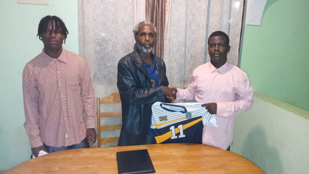 Middleham United FC executive member Julien Alexander and new signing Clayson Pascal shaking hands