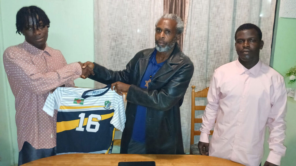 Middleham United FC executive member Julien Alexander and new signing Clayvin Pascal shaking hands