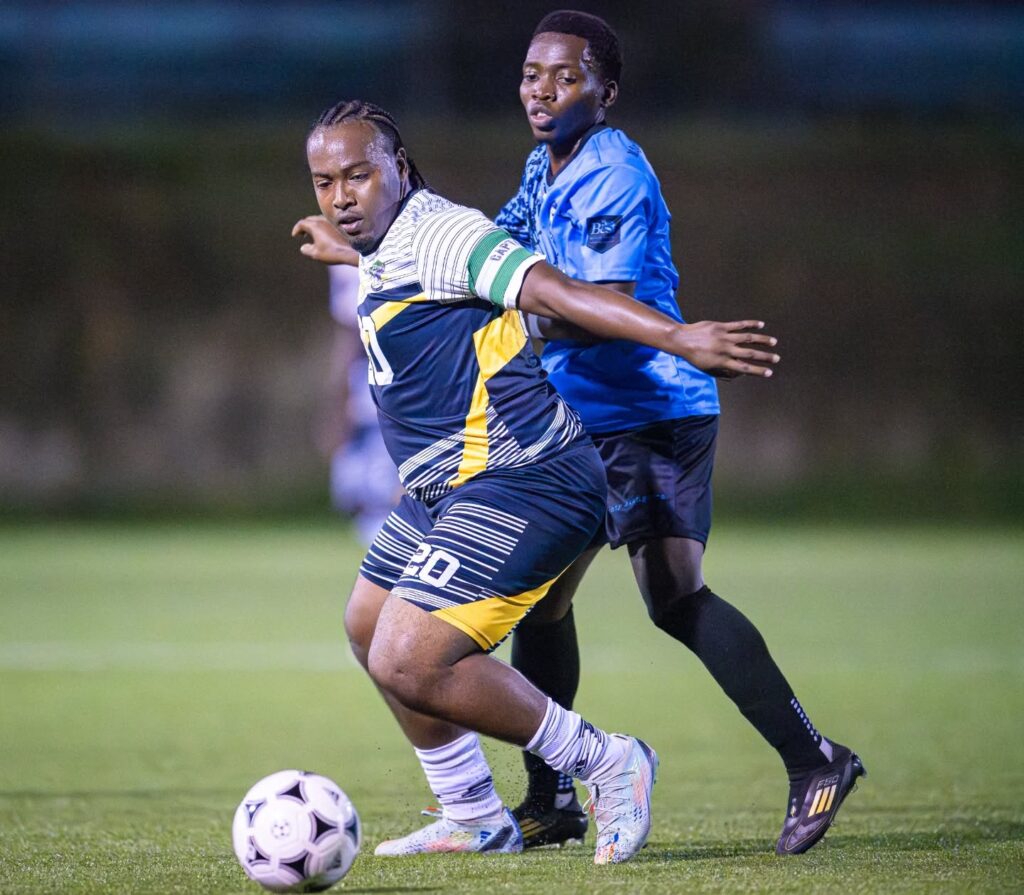 Middleham United FC player shielding the ball from an opponent