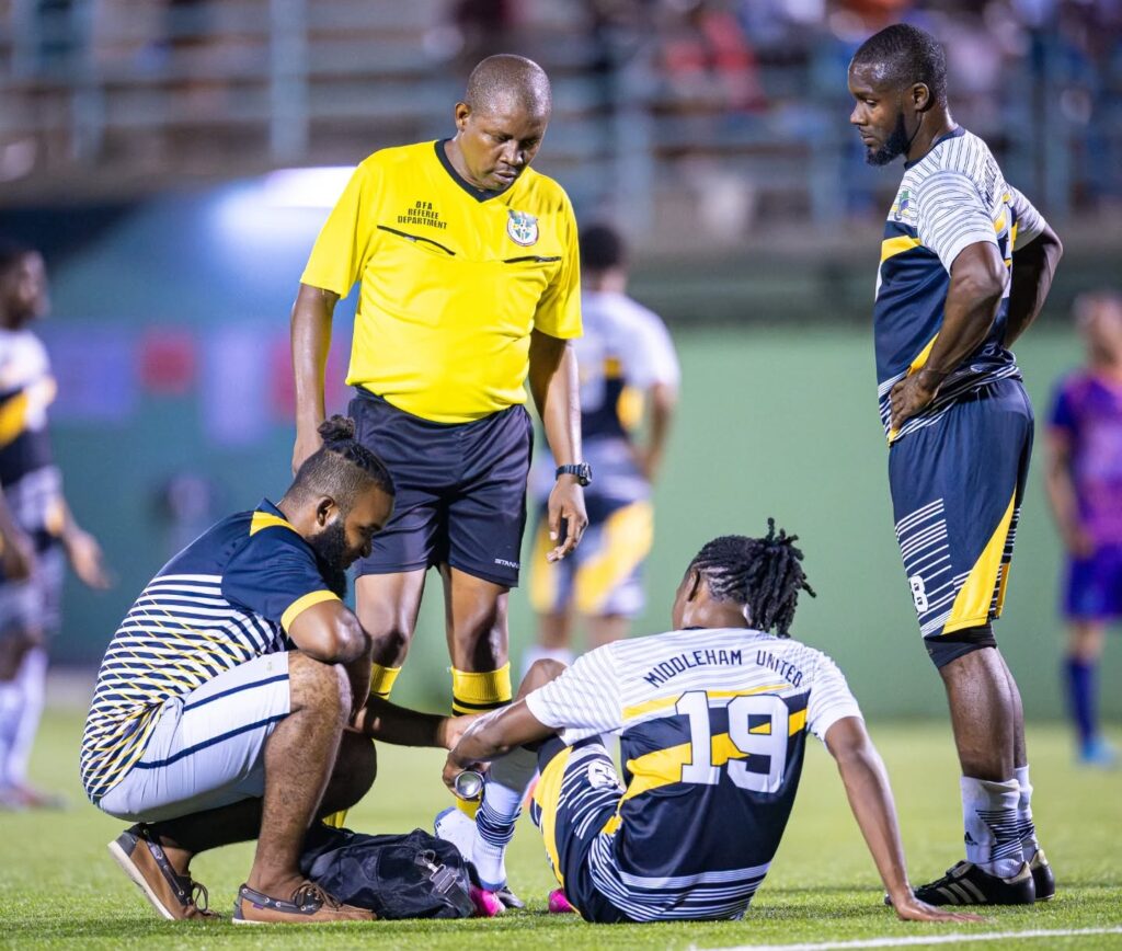 Middleham United FC medic Chad Lucien attending to an injury on the field