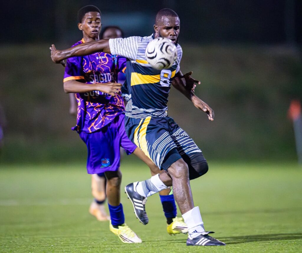 Middleham United FC player Kimon Jno. Baptiste shielding the ball from a South East FC player