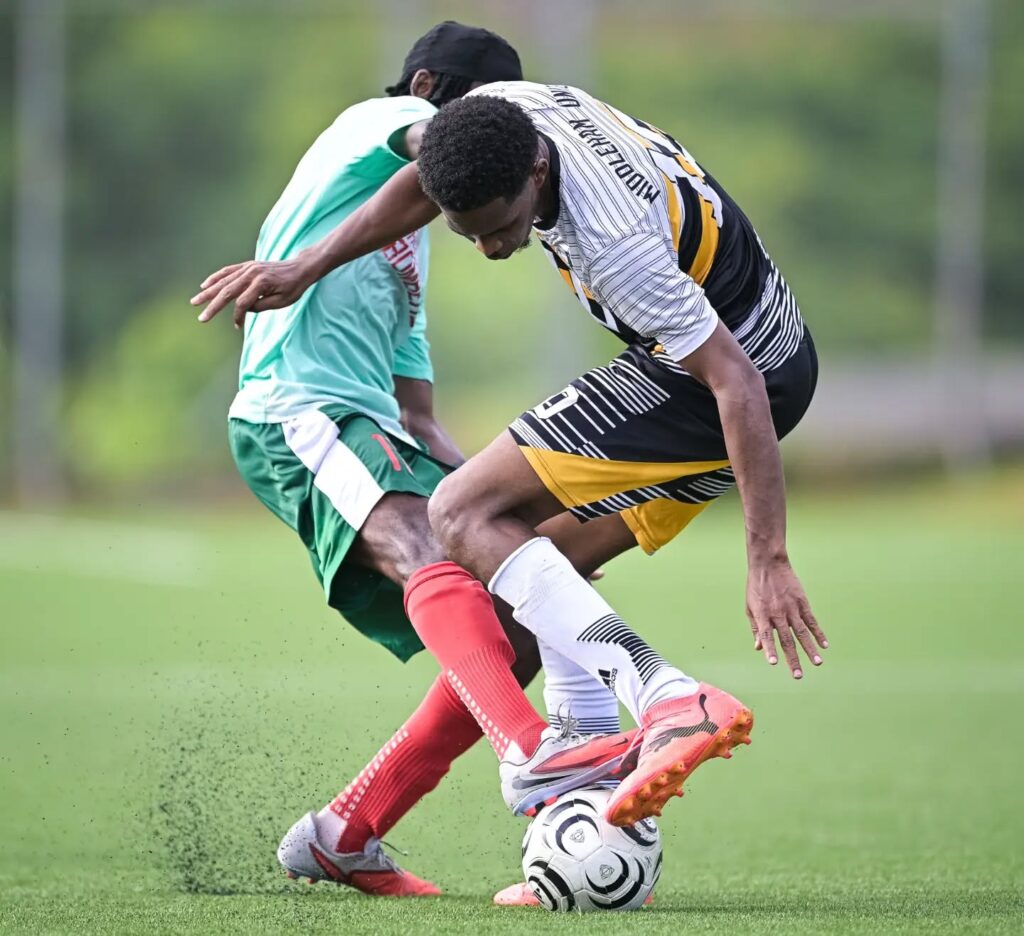 Two players attempting to win the ball in midfield