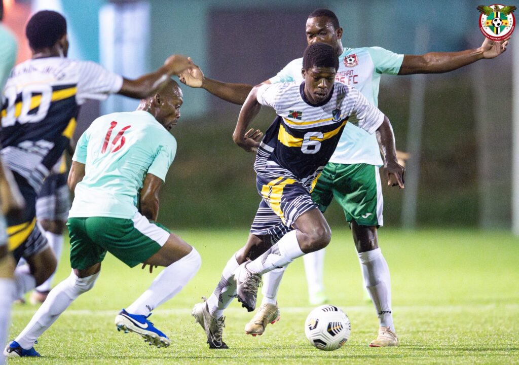 Fitzroy Benjamin dribbling passed two Portsmouth Bombers FC players