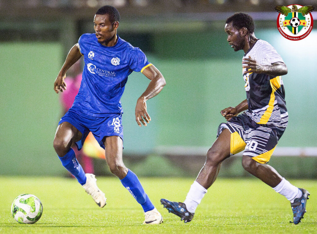Curtly Alexander applying pressure to a Dublanc FC player