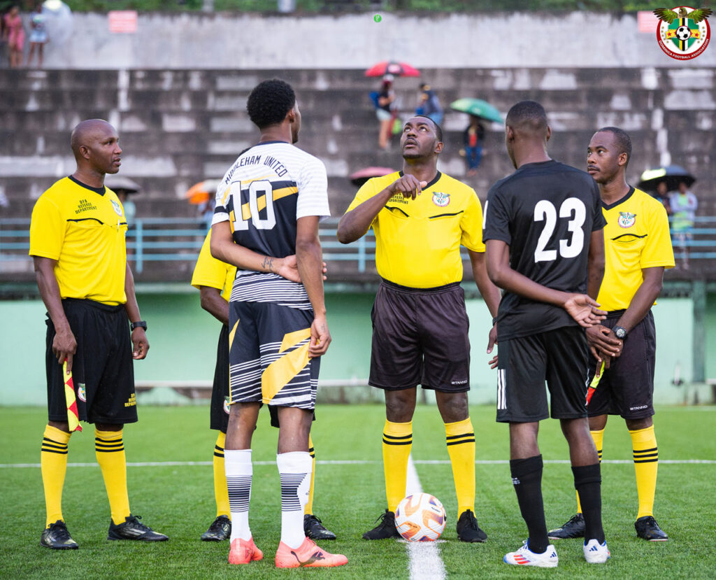 The referee tossing a coin in the air