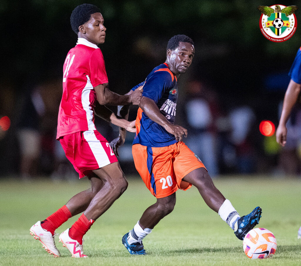 Middleham United FC player Curtly Augustine passing to a teammate while under pressure from a Bombers player