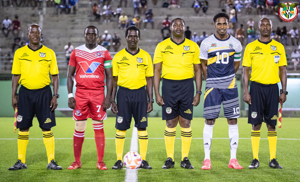Officials and team captains posing for a photo before the week 13 match