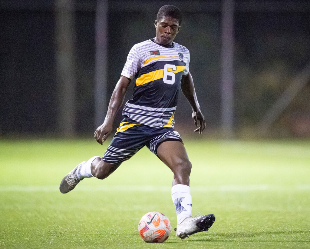 Middleham United FC player Fitzroy Benjamin making a pass