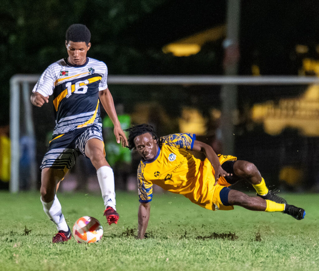 Middleham United FC player Kenneth Valmond shielding the ball from a Dublanc FC player