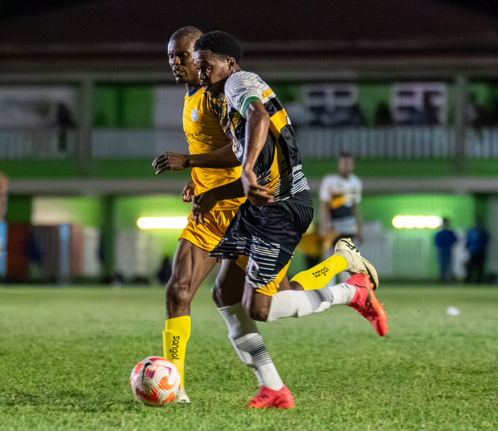 Middleham United FC player Marcelus Bonney running with the ball in midfield