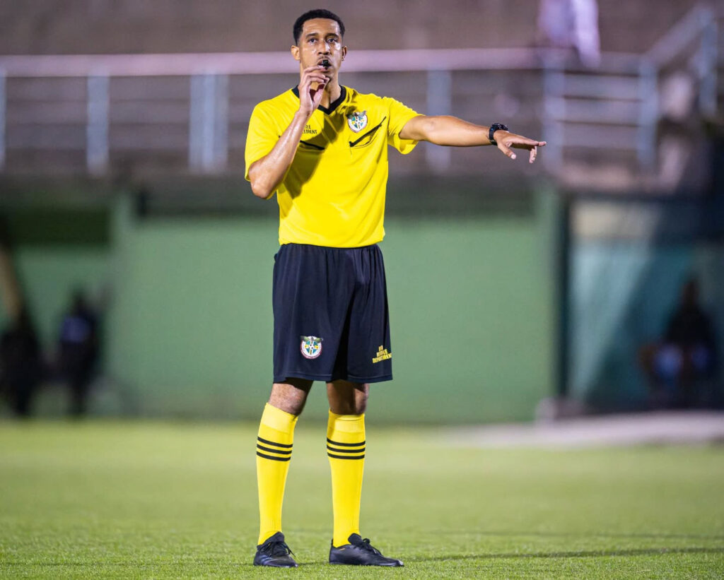 The match official blowing the full time whistle